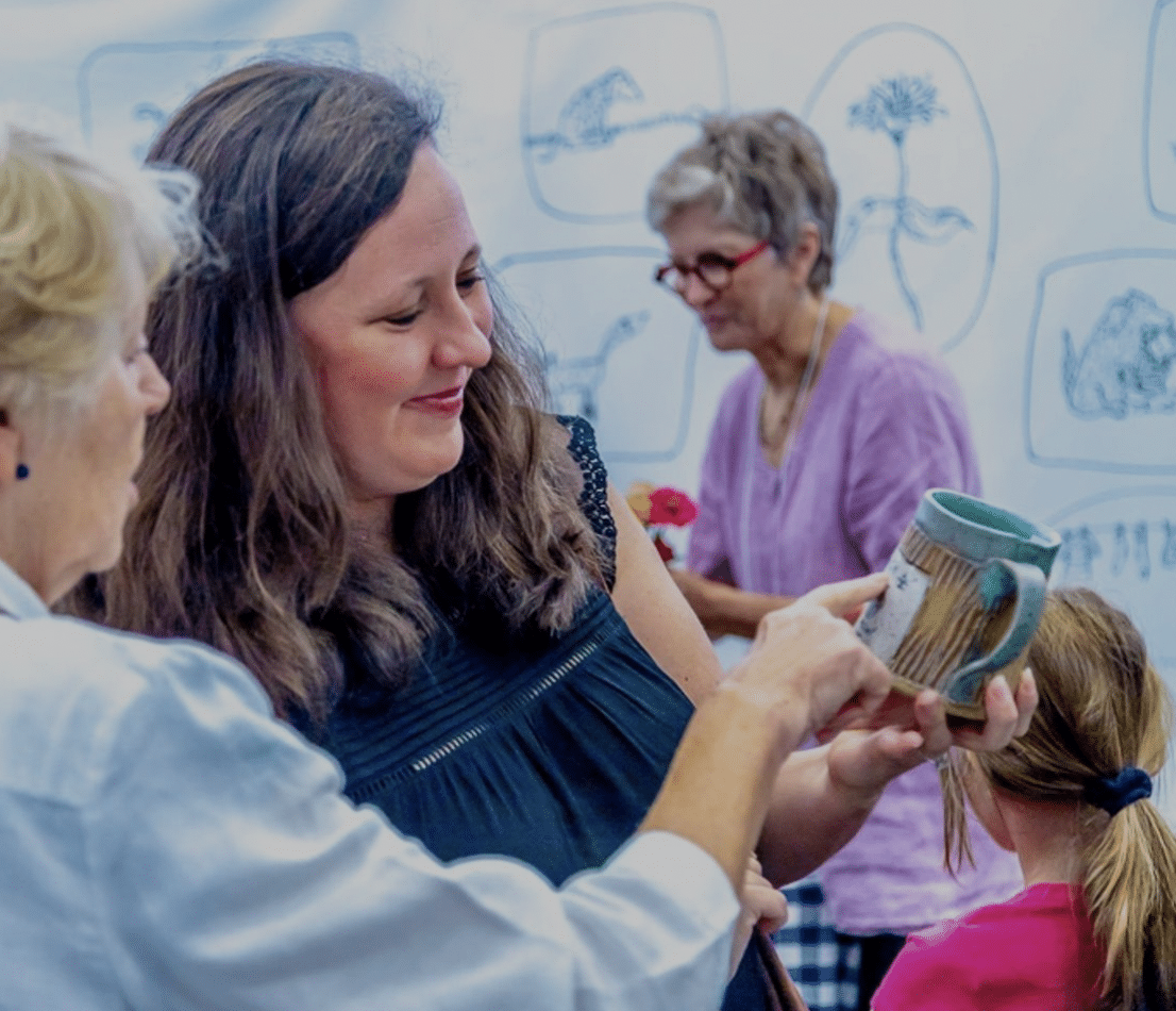 Woman admiring a handmade clay mug