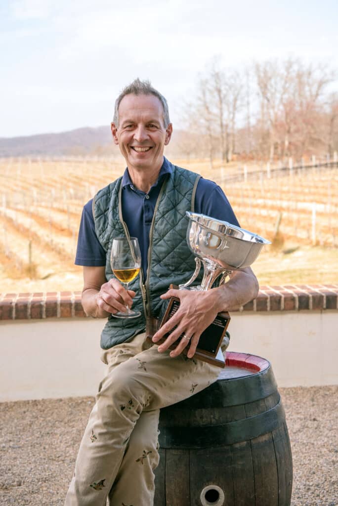 Winemaker Luca Paschina holding Governor's Cup Trophy and sipping the winning passito wine, Barboursville Vineyards Paxxito