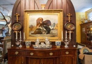 Oil painting of hunting dog in gilt frame at Middleburg Antiques Gallery in Middleburg, VA