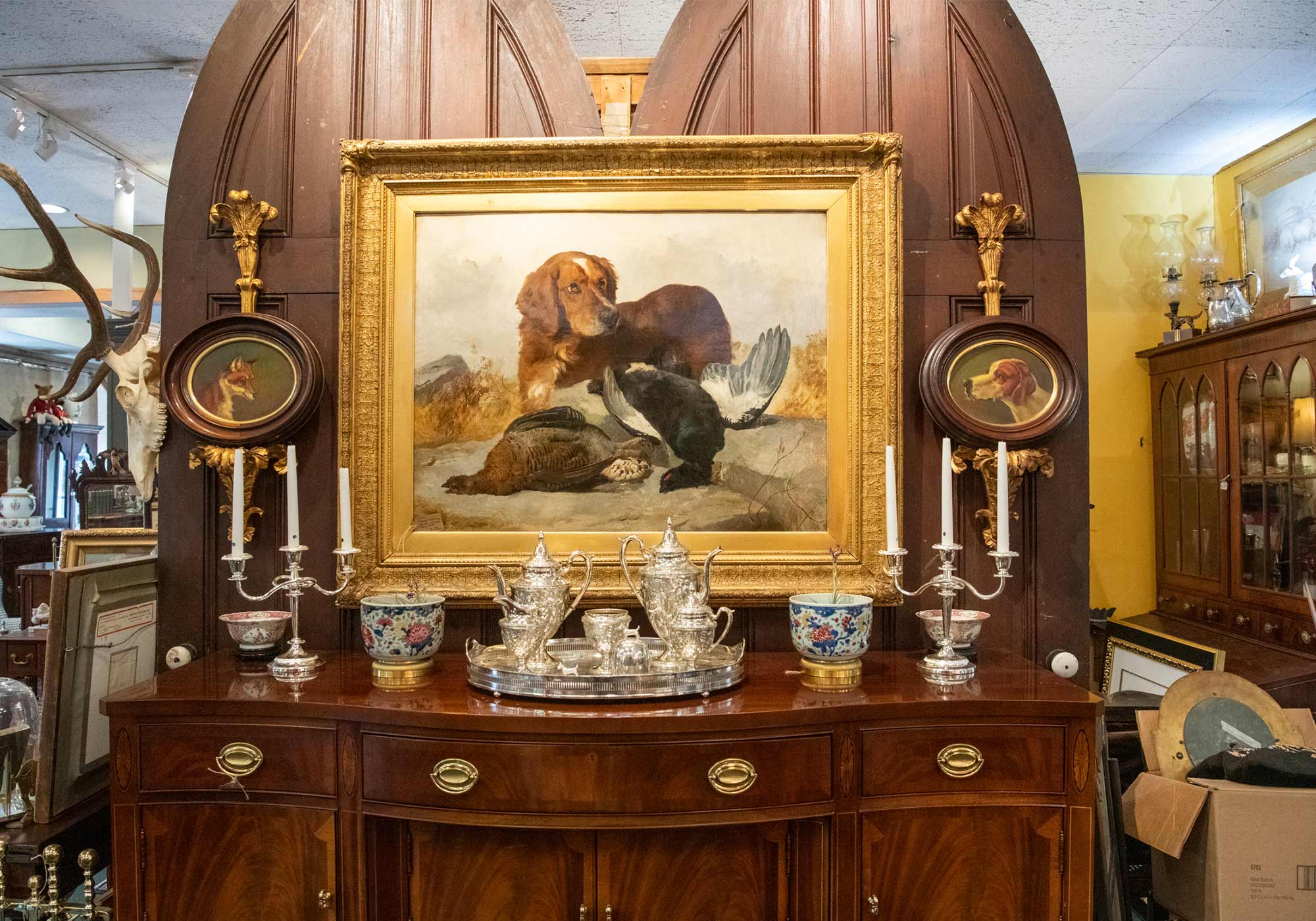 Oil painting of hunting dog in gilt frame at Middleburg Antiques Gallery in Middleburg, VA