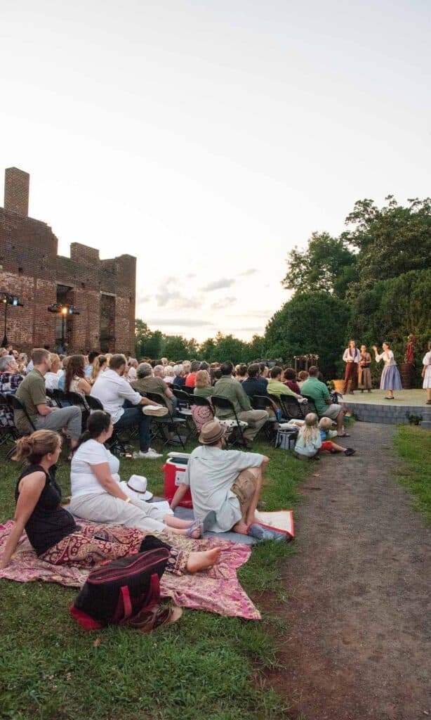 Guest enjoying picnics and Shakespeare at the Ruins theatre performed outdoors at the Barboursville Vineyards in Virginia Wine Country.