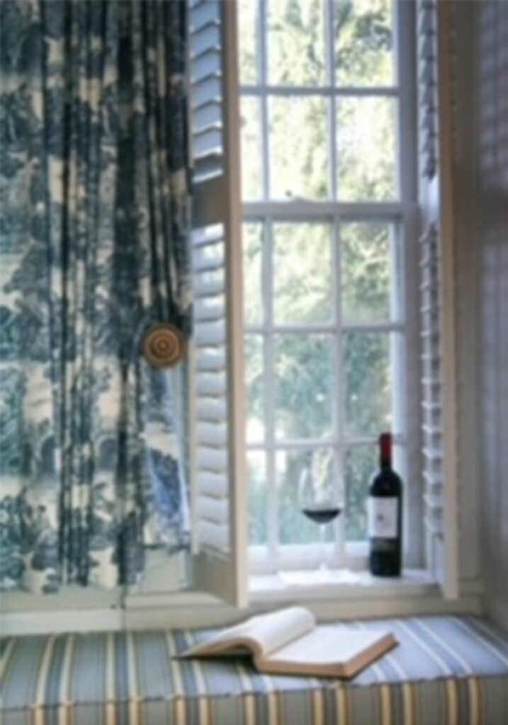A sweet window seat with blue toile draperies in a bedroom suite at the 1804 Inn. Barboursville Vineyards.