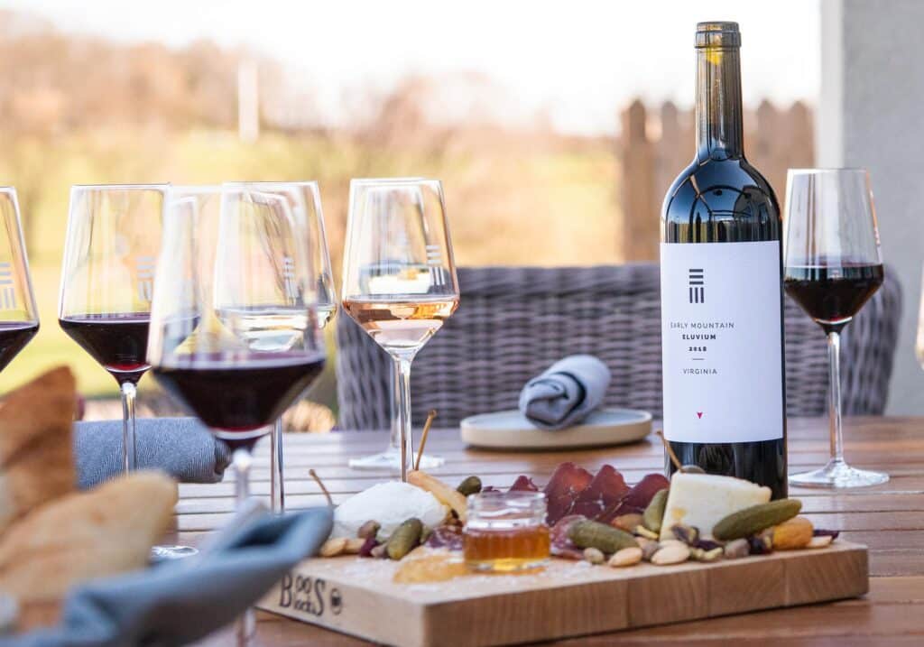 Early Mountain Vineyards Eluvium wine served outdoors at the Virginia winery with charcuterie.