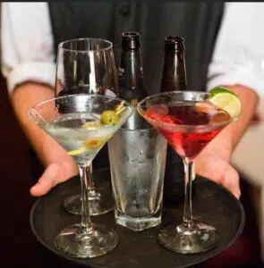 Close-up photo of a server holding a tray of drinks at Aberdeen Barn