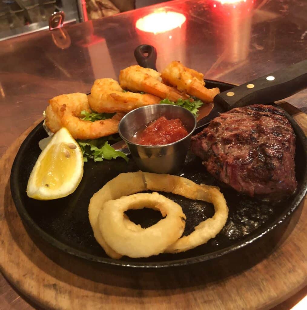 Photo of a steak dinner, onion rings, shrimps at Aberdeen Barn