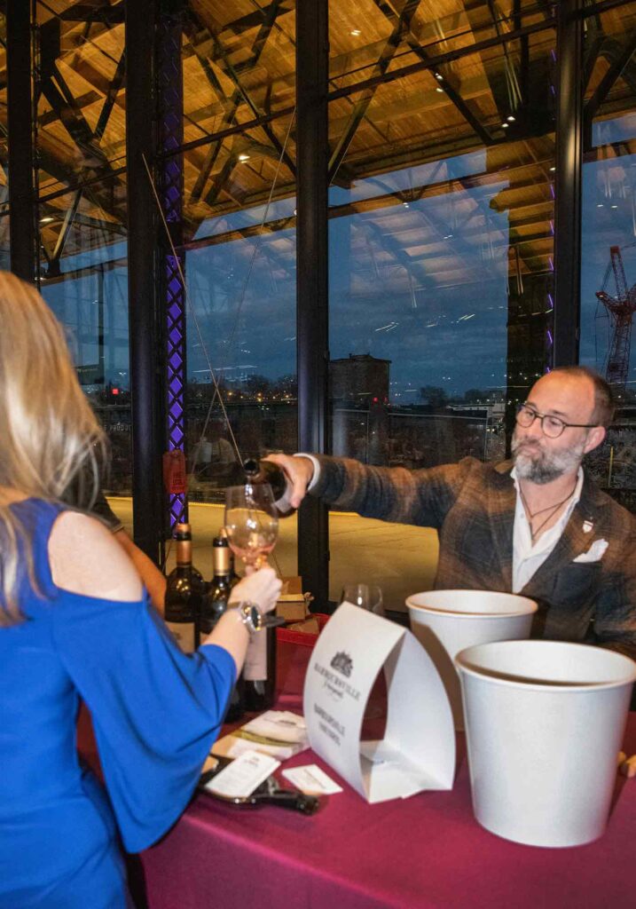 Alessandro Medici, Sommelier at Barboursville Vineyards and Palladio, pours wine at the Virginia Governor's Cup Gala 2023 honoring Virginia's best wines.