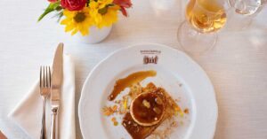 Chef-prepared dish at Barboursville Vineyards paired with wine and presented on white linens at Tuscan Feast, a collaboration with Castilla Di Abolla.