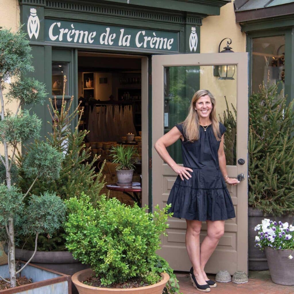 Photo of Tara Wegdam in front of Creme de la Creme shop in Middleburg Virginia