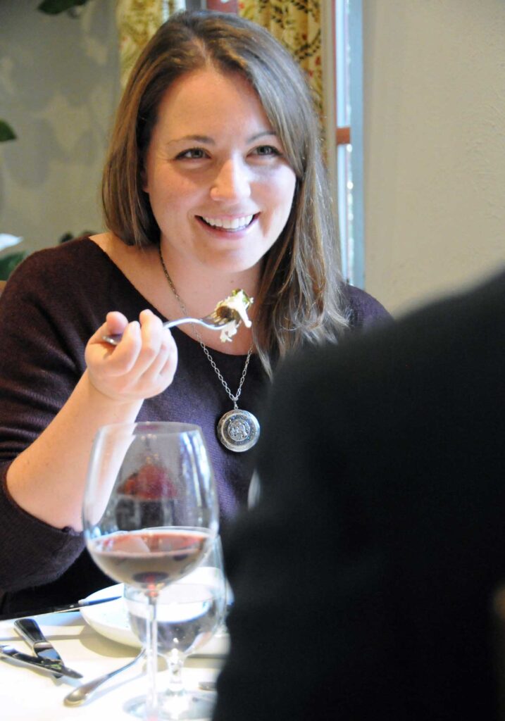 Young woman enjoying a truffle dish while dining at the winery restaurant Palladio of Barboursville Vineyards.