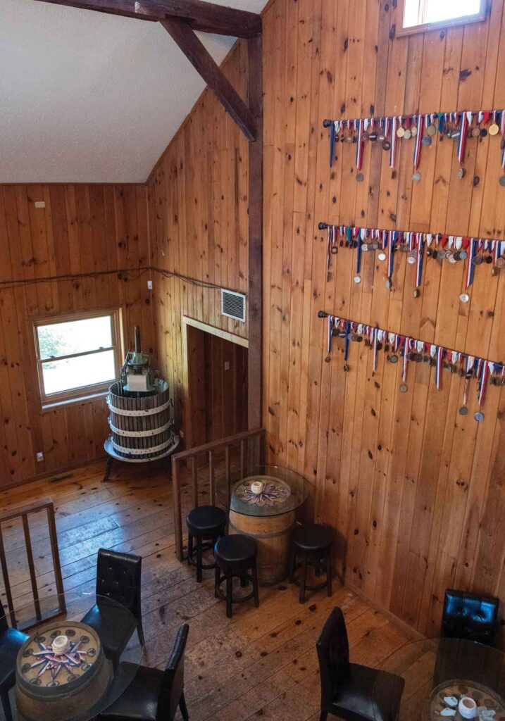 The Shenandoah Vineyards vaulted tasting room with display of wine award medals and antique wine press.
