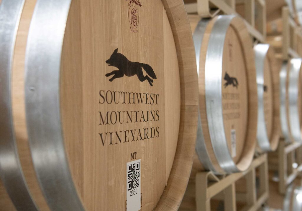 Wine barrels at Southwest Mountains Vineyards with running fox image.