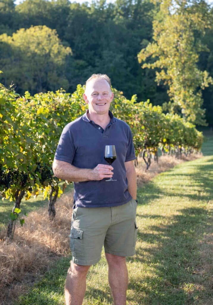 Winemaker Boela Gerber enjoying a glass of red wine amongst the vines at Southwest Mountains Vineyards, a Monticello Wine Trail winery.