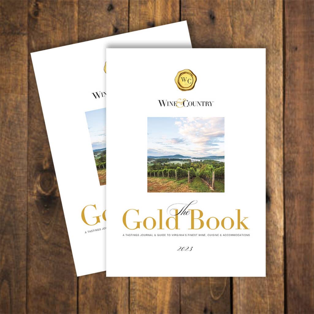Stacked copies of the 2023 Wine & Country Gold Book, a wine tasting journal. RdV Vineyards is featured on cover.