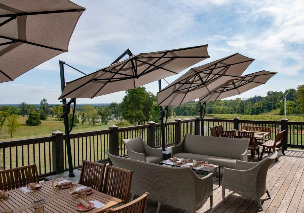 Southwest Mountains Vineyards’ outdoor patio with tan umbrellas