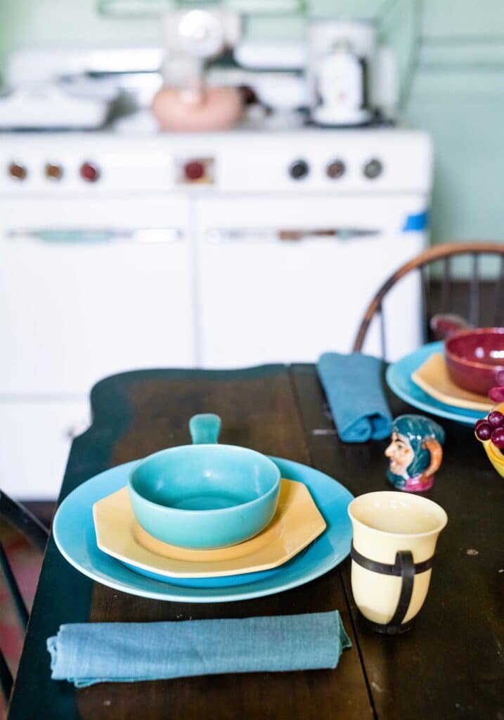A table setting with vintage dishes in blues and yellows. Poet Anne Spencer's kitchen.