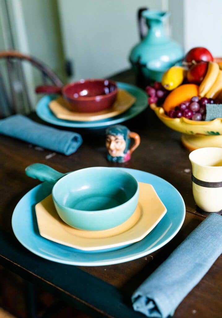 A table setting with vintage dishes in blues and yellows. Poet Anne Spencer's kitchen at the Lynchburg, Va Anne Spencer Home & Garden Museum.