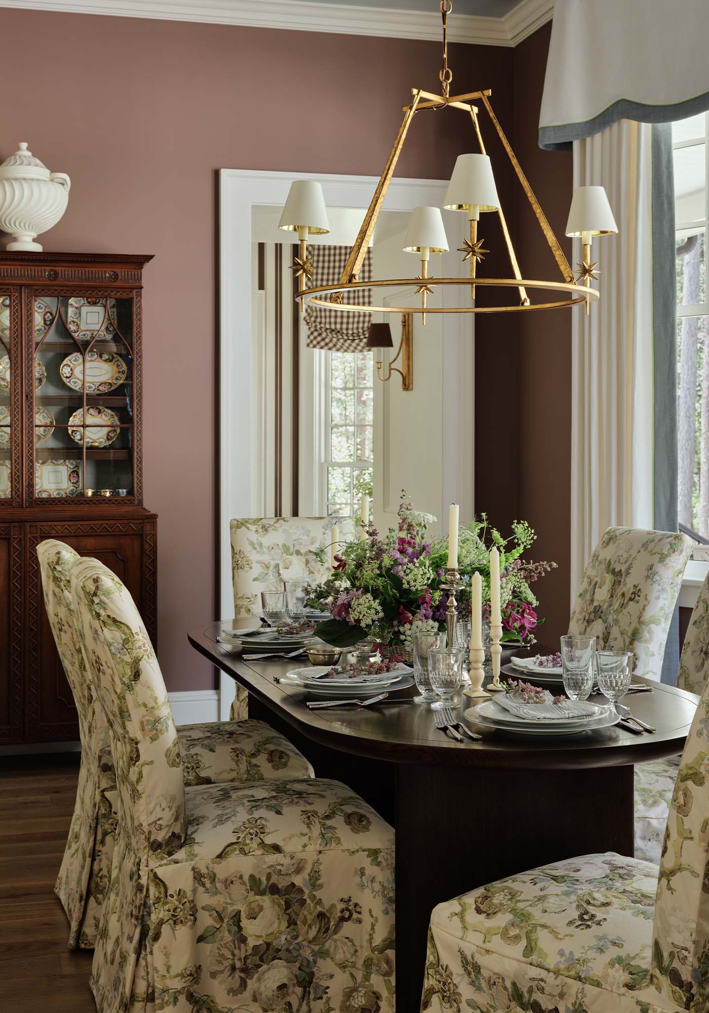 Elegant dining room in the 2025 Southern Living Idea House by Charlotte Moss with antique mahogany buffet, oval dining table, and a blend of modern and traditional décor.