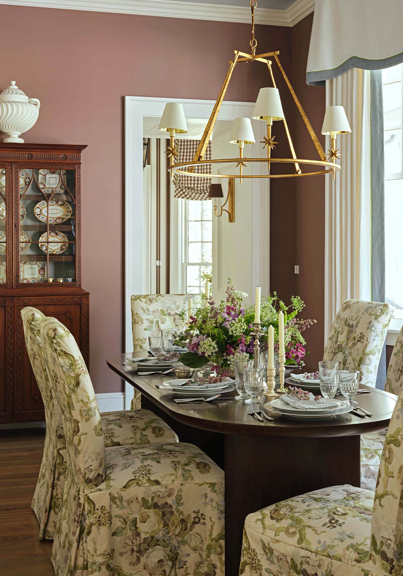 Elegant dining room in the 2025 Southern Living Idea House by Charlotte Moss with antique mahogany buffet, oval dining table, and a blend of modern and traditional décor.