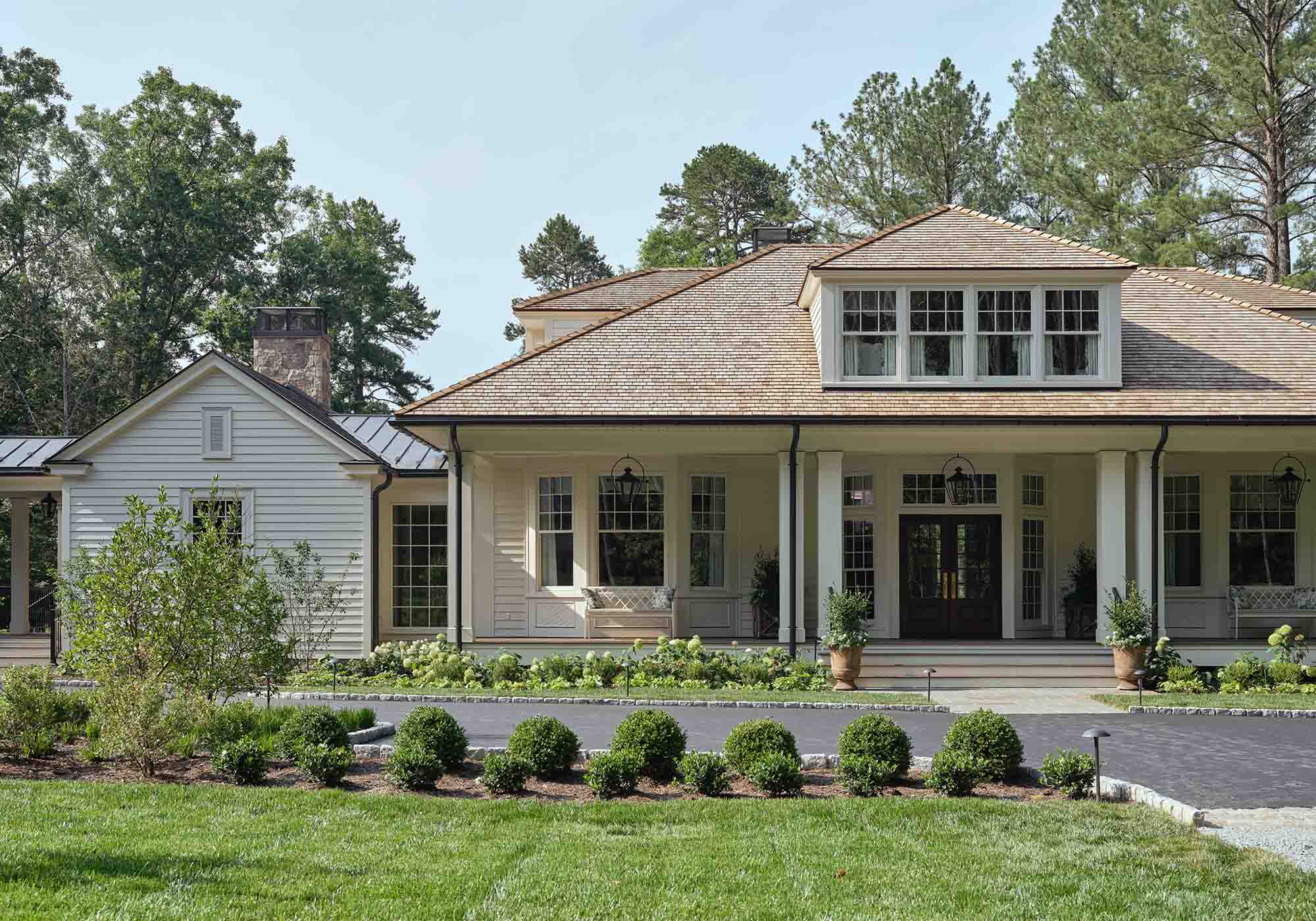 Exterior of the 2025 Southern Living Idea House in Keswick, Virginia, designed by Charlotte Moss, with deep porches, Appalachian hardwood planters, and views of rolling hills.