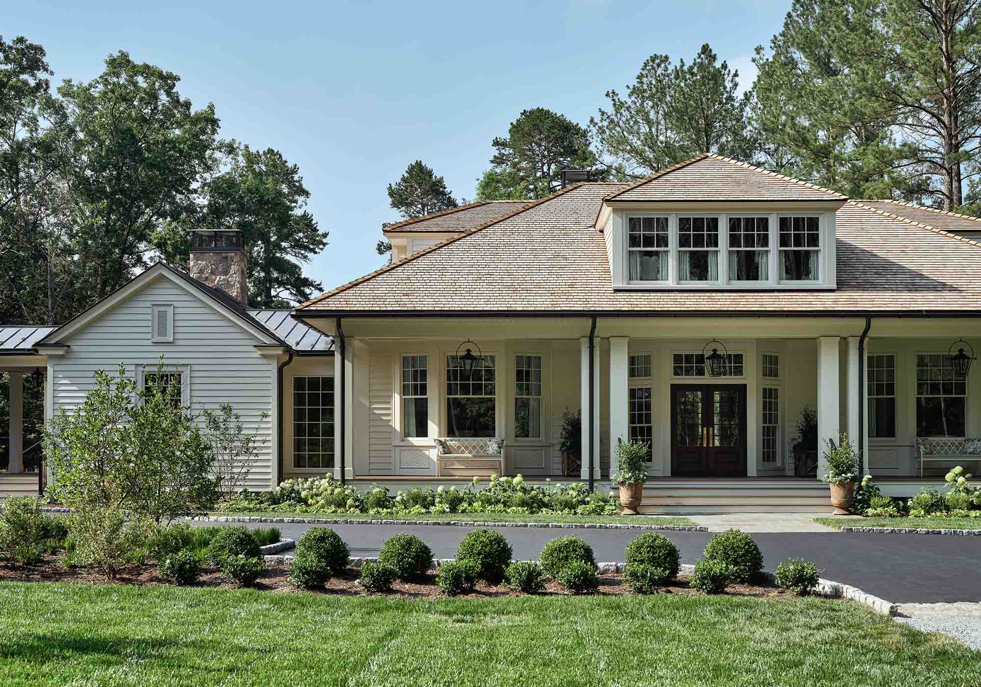 Exterior of the 2025 Southern Living Idea House in Keswick, Virginia, designed by Charlotte Moss, with deep porches, Appalachian hardwood planters, and views of rolling hills.