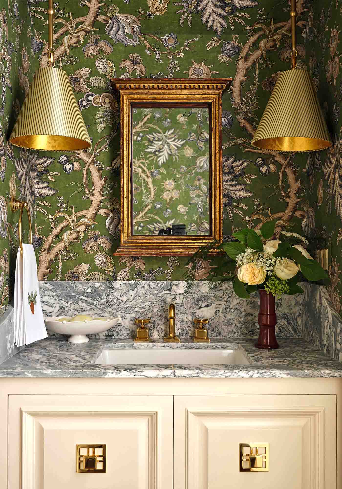 Downstairs hall powder room in the 2025 Southern Living Idea House by Charlotte Moss, featuring elegant wallpaper, a classic vanity, and polished fixtures.
