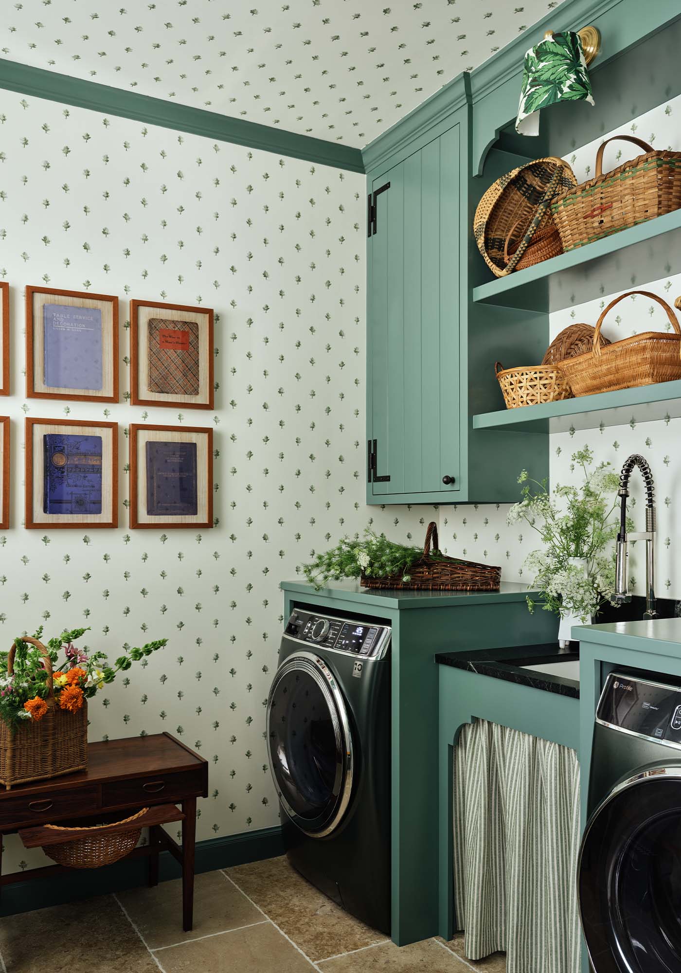Laundry room in the 2025 Southern Living Idea House designed by Charlotte Moss, featuring botanical tree-print wallpaper and GE Profile appliances.