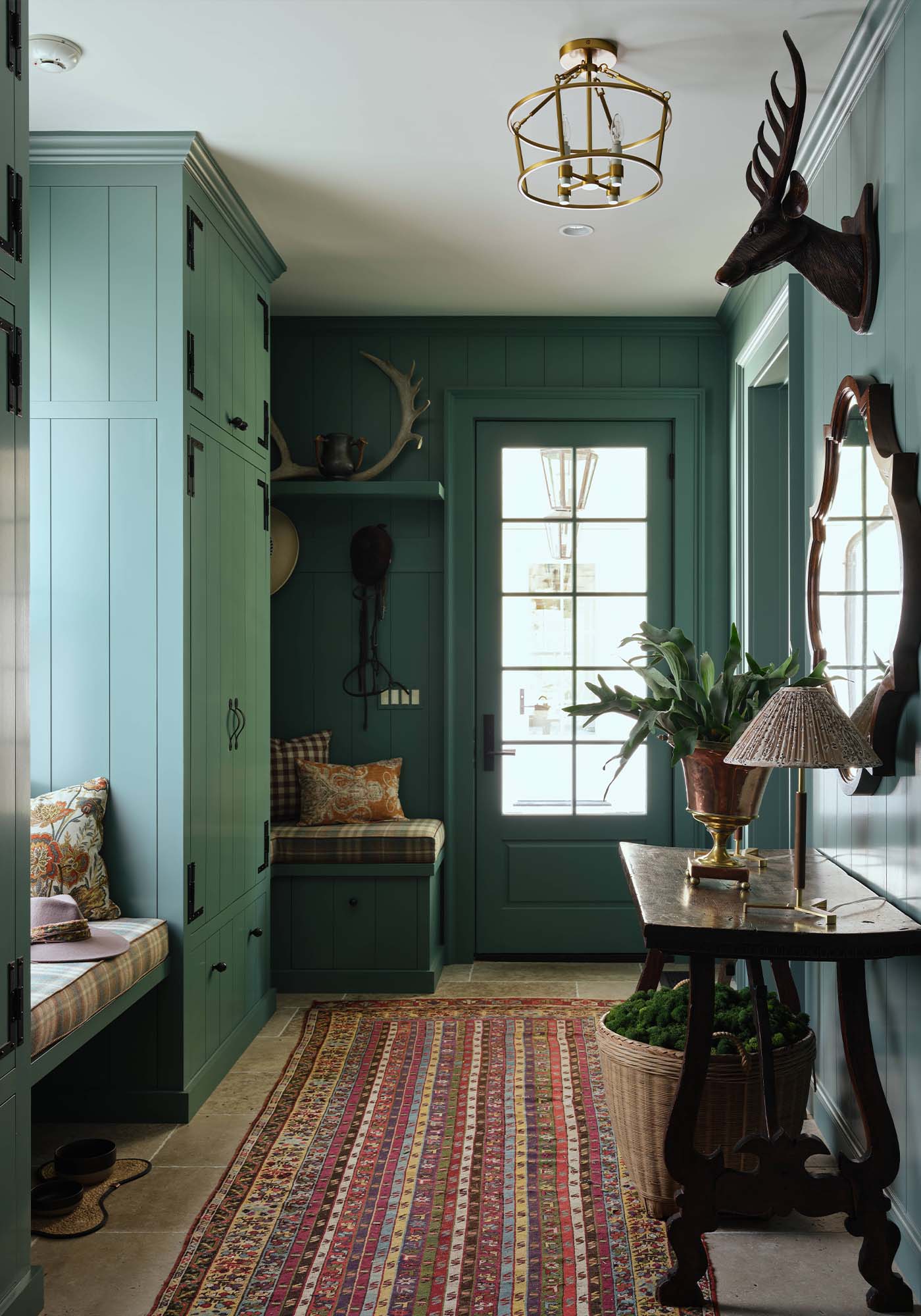 Functional boot room in the 2025 Southern Living Idea House by Charlotte Moss, with plaid Nevis seating, hidden storage, and Studio Blue Green painted cabinetry.
