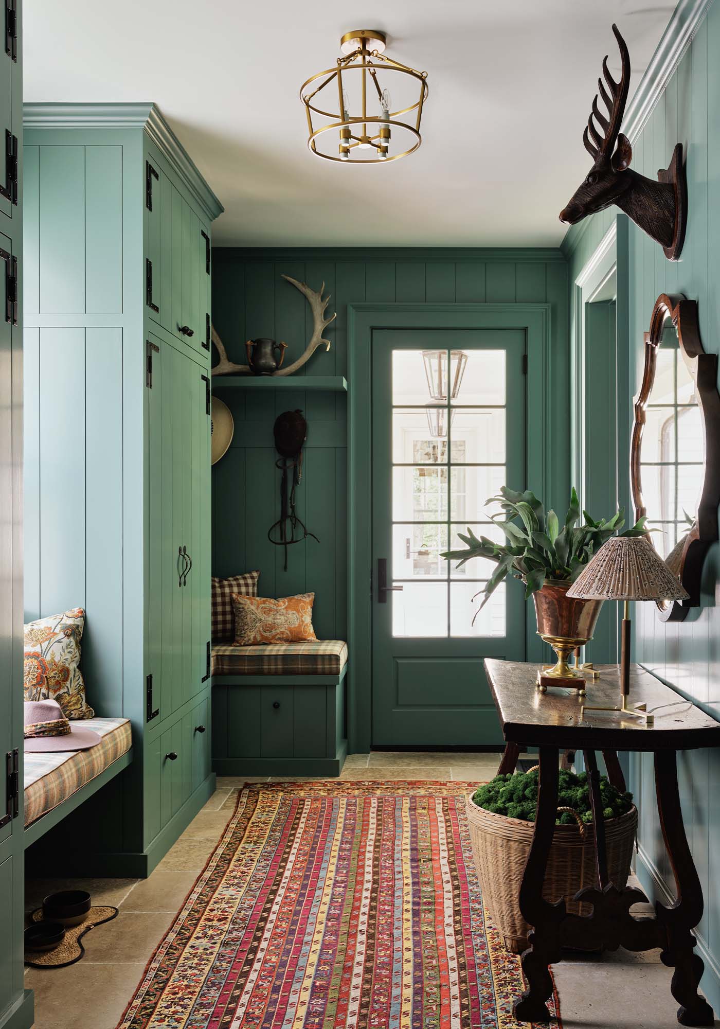Functional boot room in the 2025 Southern Living Idea House by Charlotte Moss, with plaid Nevis seating, hidden storage, and Studio Blue Green painted cabinetry.