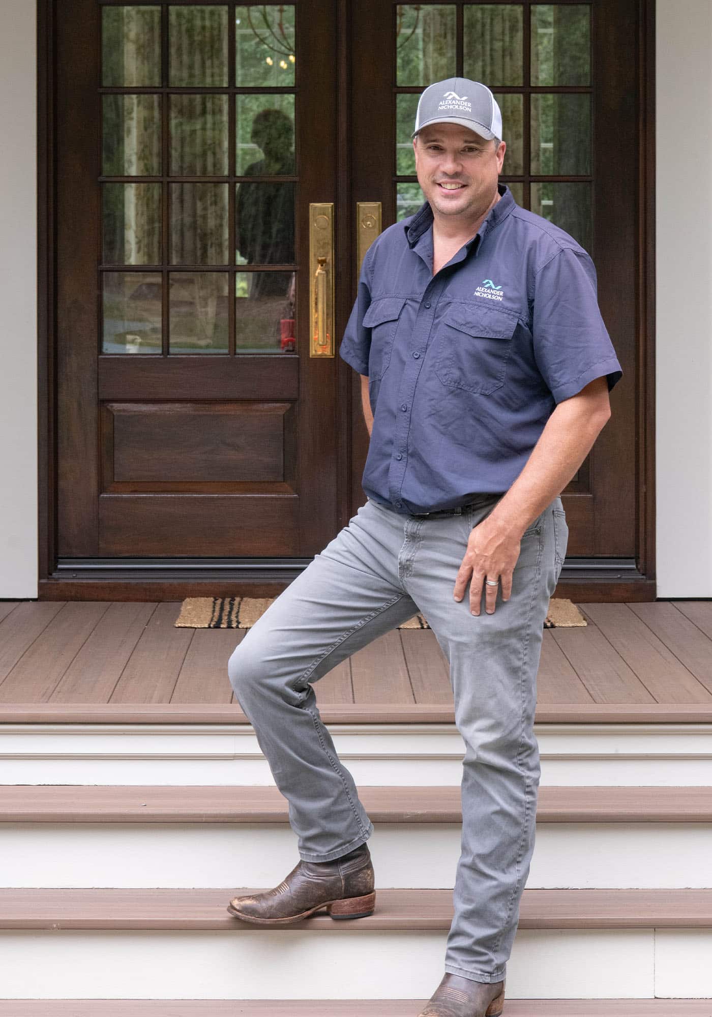 Headshot of the builder of the 2025 Southern Living Idea House, smiling and posed in front of the construction site in Keswick, Virginia.
