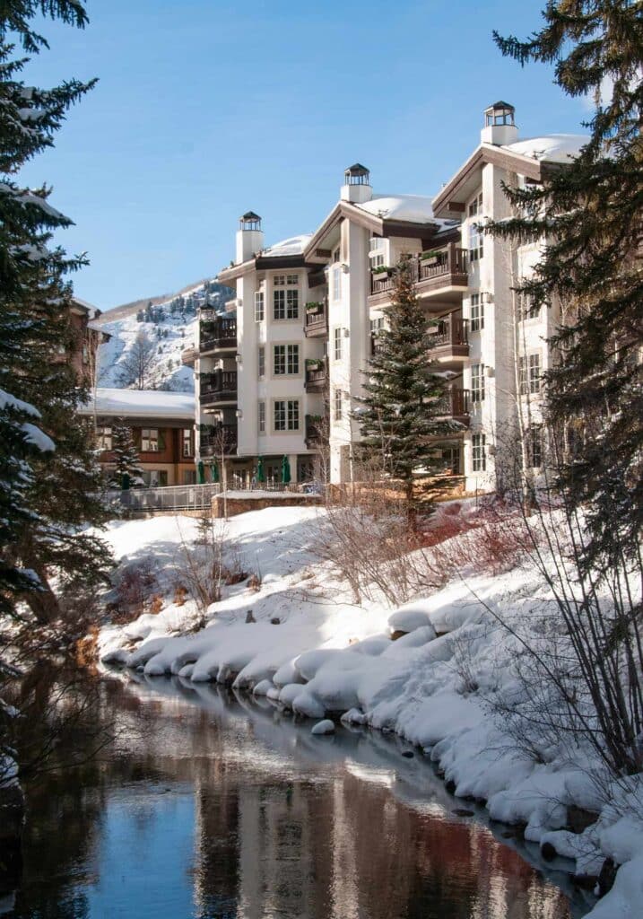 Exterior view of Austria Haus Hotel in Vail, Colorado, as seen from snow-covered Gore Creek.