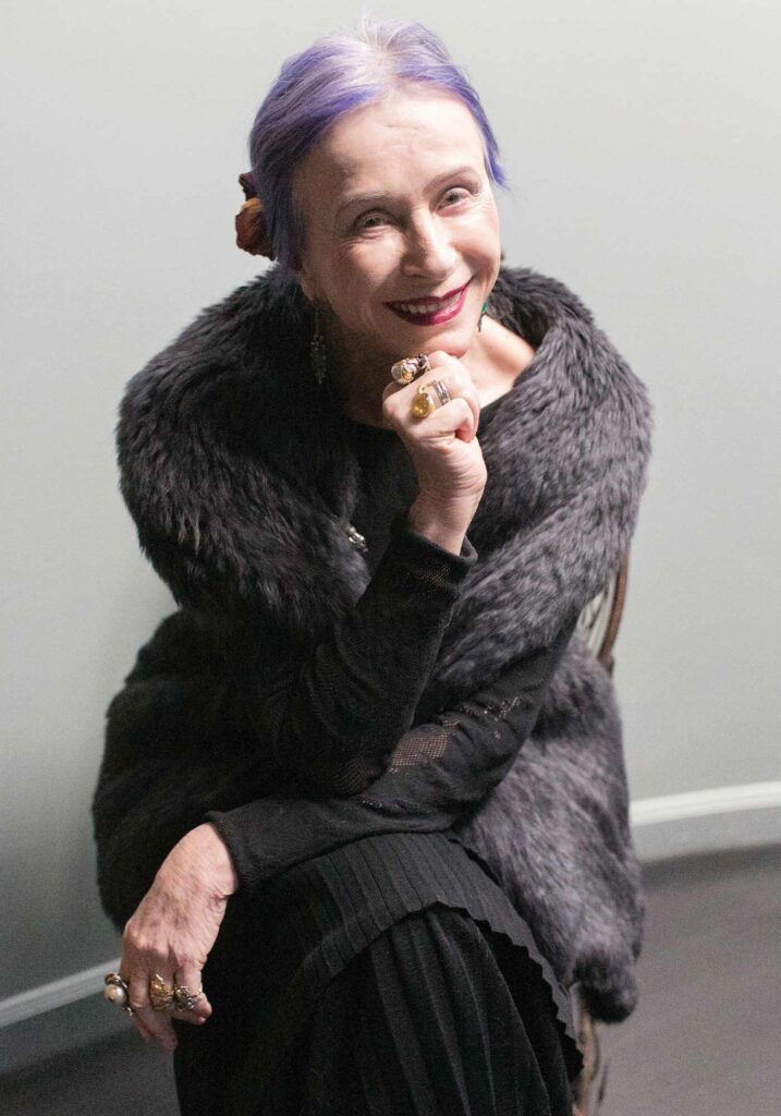 smiling portrait of artist Beatrix Ost in her Charlottesville studio