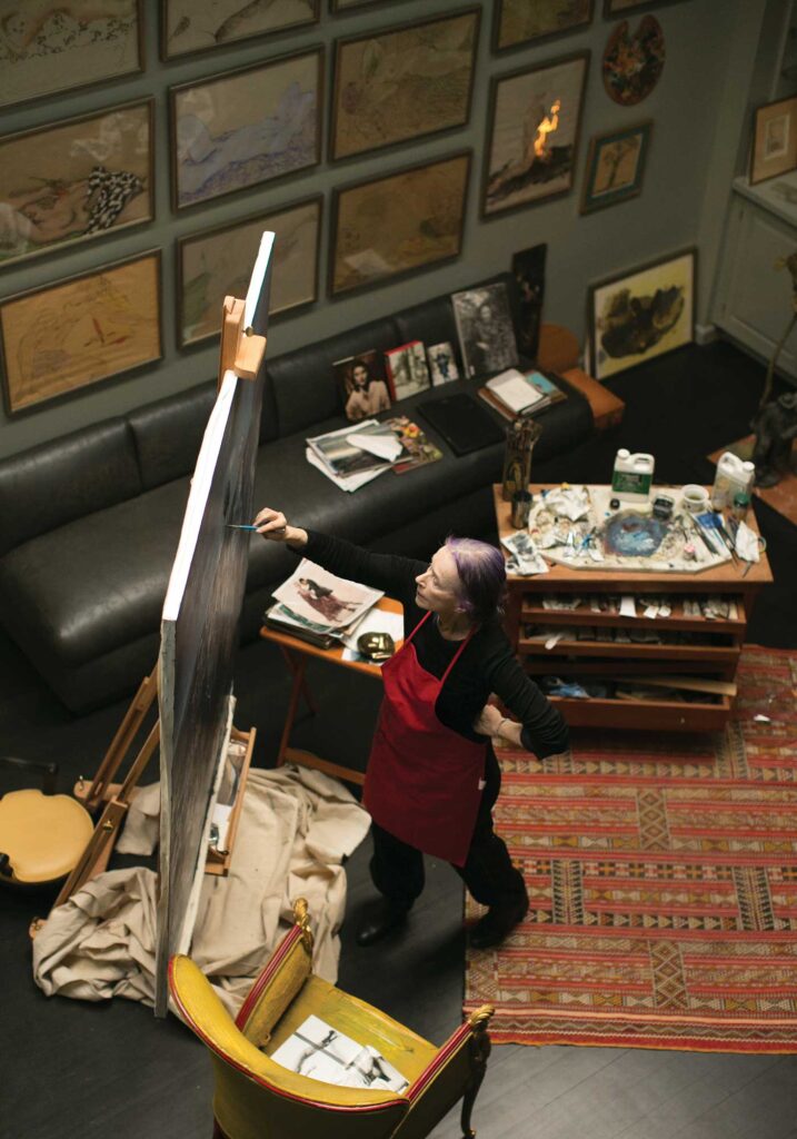 photo of Charlottesville artist Beatrix Ost painting in her art studio