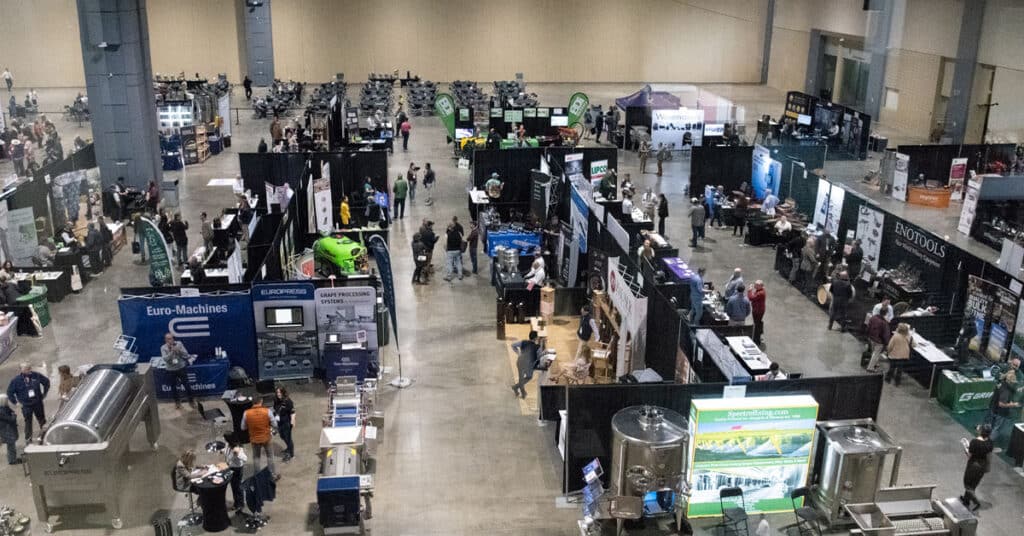 Trade show floor at the 2026 Eastern Winery Exposition featuring vineyard and winemaking equipment
