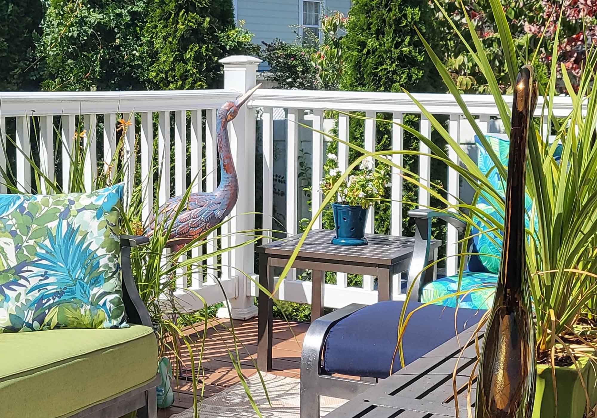 Danville-Chatham terrace with metal heron sculpture and lush ferns on display during 2026 Historic Garden Week