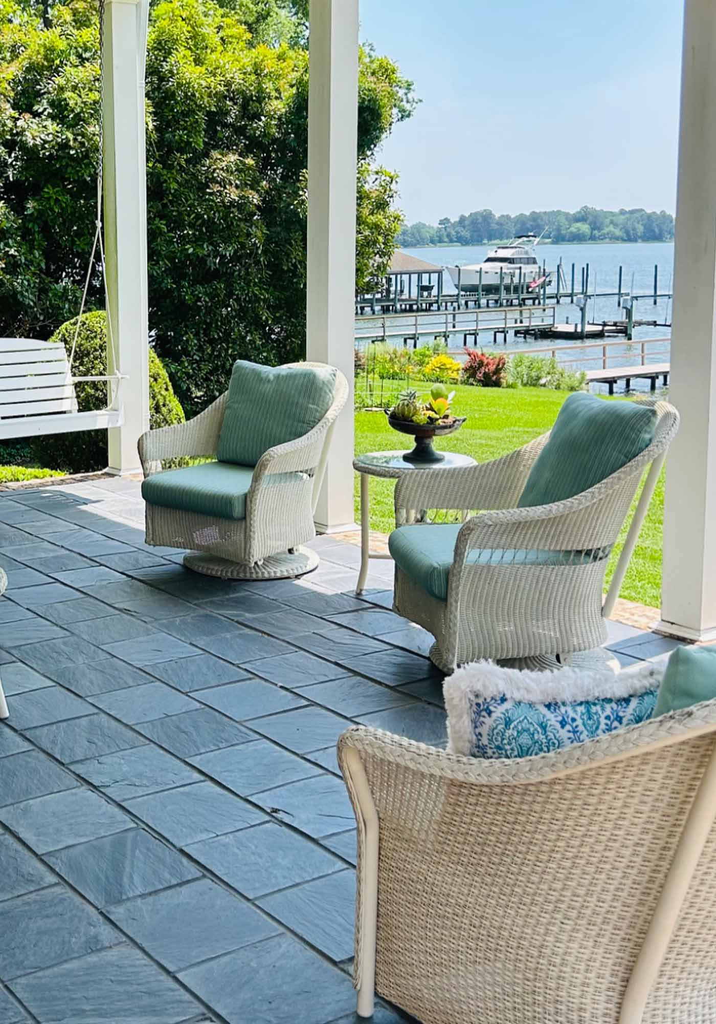 Waterside porch in Portsmouth, Virginia with piers in the background featured during 2026 Historic Garden Week