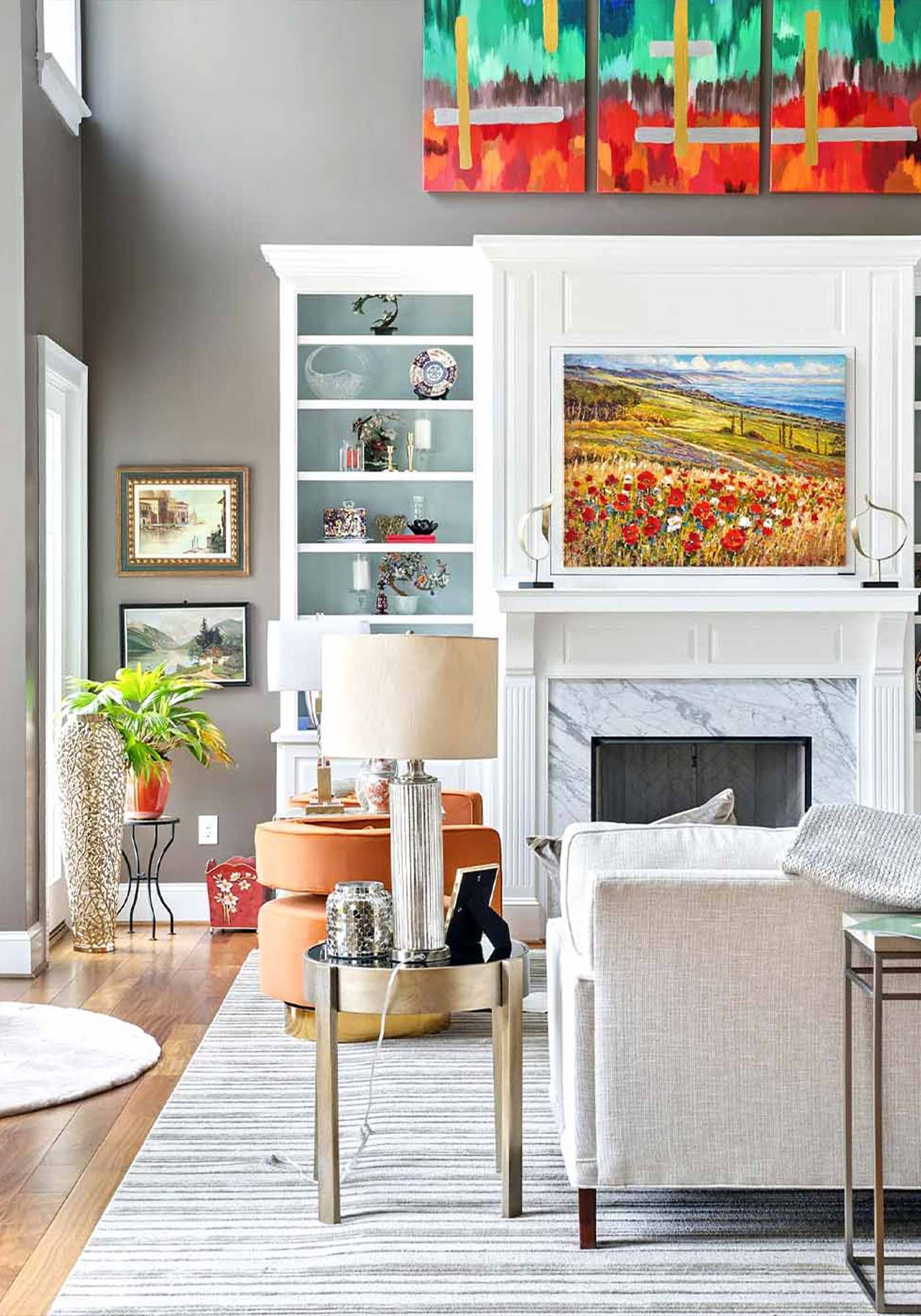 Modern white and gray living room with colorful art and marble fireplace in South Gaskins Road, Richmond, featured during Historic Garden Week 2026