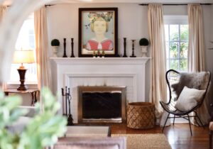 stylish living room with a fireplace and large painting over it.