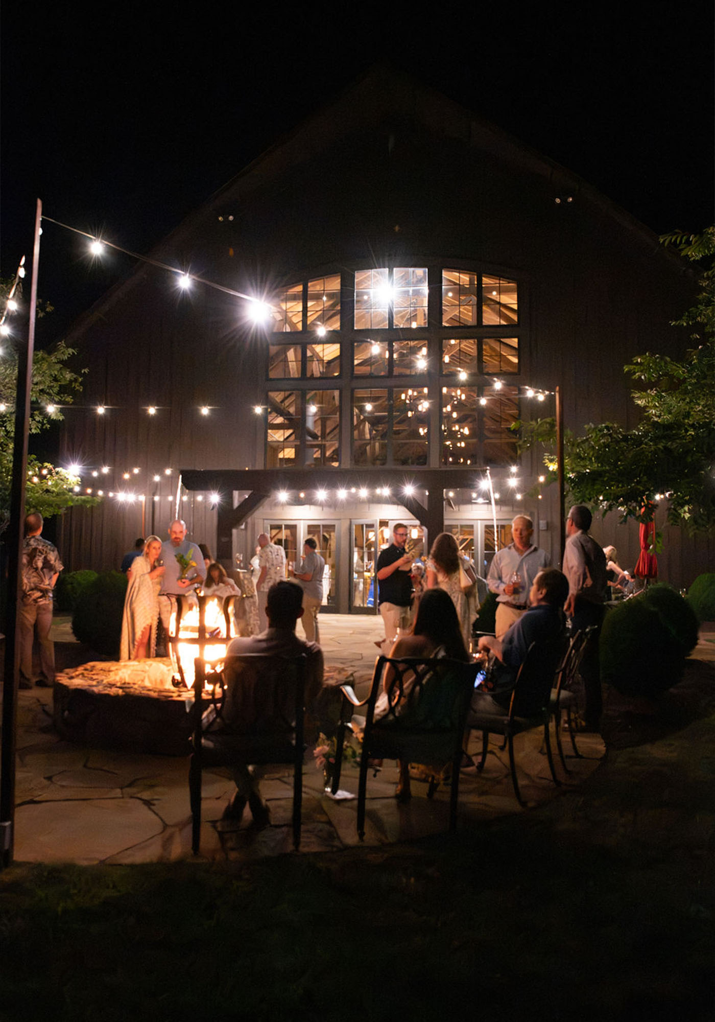 Guests around the fire pit at night at the Southwest Mountains Vineyards solstice dinner event